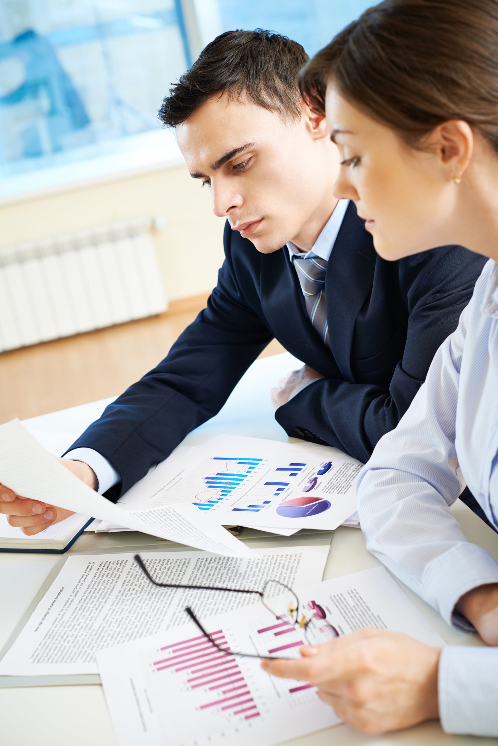 coworkers-reviewing-some-reports-min