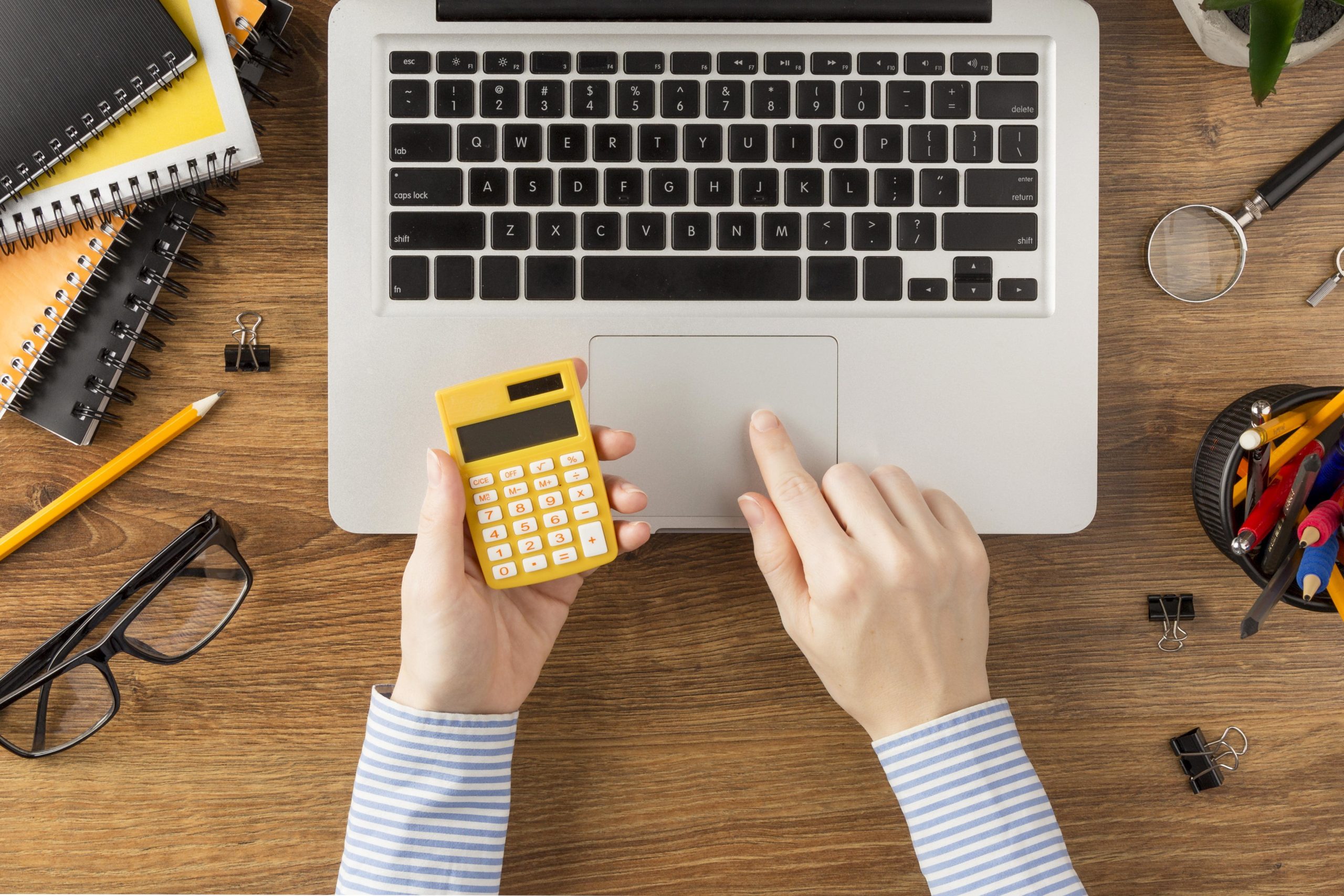 top-view-student-holding-calculator-min