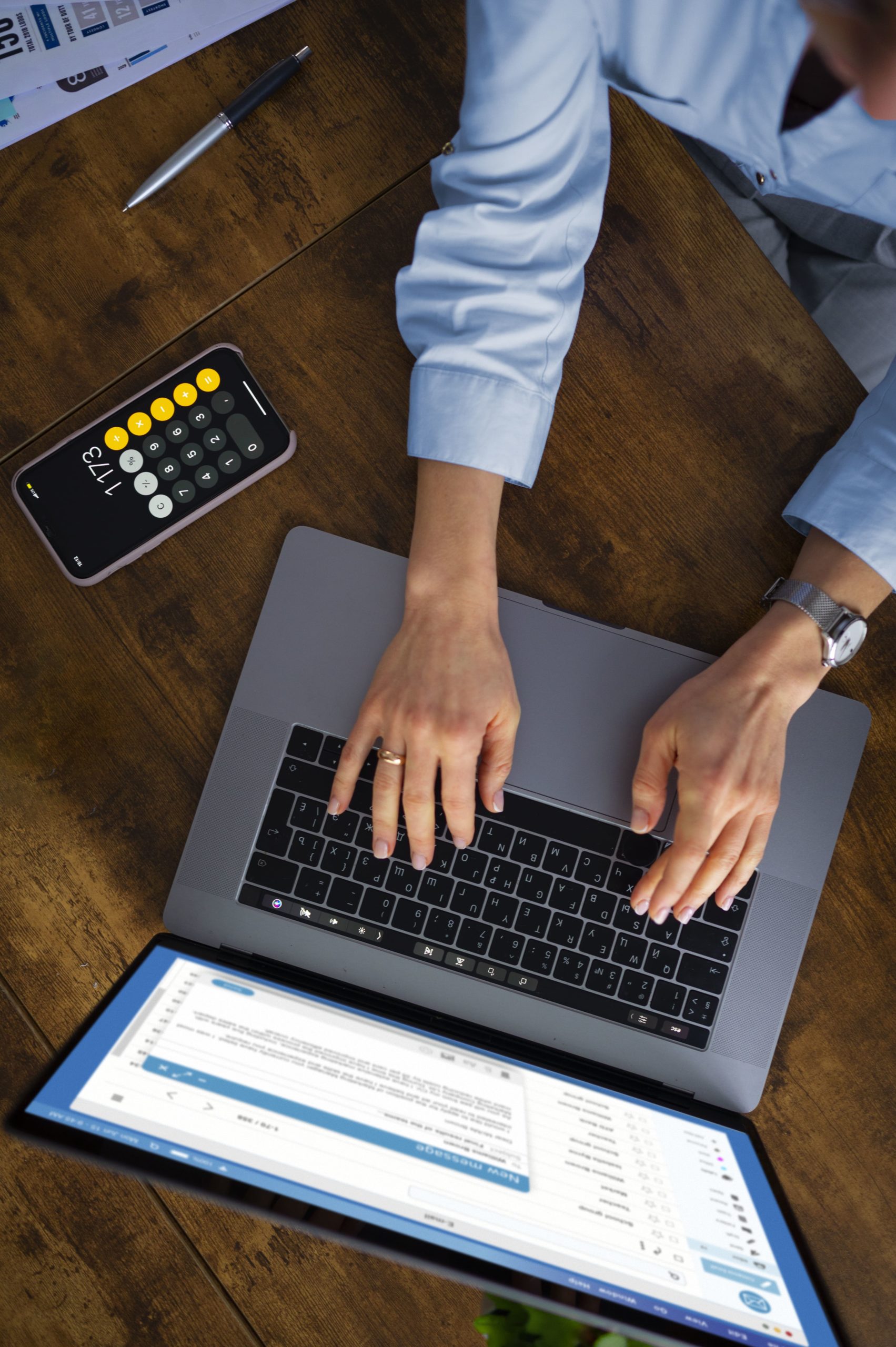 view-woman-typing-laptop-min
